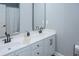 Bathroom with double sinks, white cabinets, black hardware, and a mirror at 1131 Camellia Dr., Surfside Beach, SC 29575