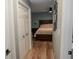 Bedroom with wood floors, a bed, a closet, and photos on the wall at 1131 Camellia Dr., Surfside Beach, SC 29575