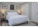 Bedroom featuring a plush white bed, side tables with lamps, and double closets at 1131 Camellia Dr., Surfside Beach, SC 29575