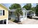 Charming two-story beach house with a two-car garage and mature palm trees at 1131 Camellia Dr., Surfside Beach, SC 29575