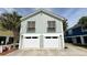 Two-story beach house with a two-car garage and a palm tree in the front yard at 1131 Camellia Dr., Surfside Beach, SC 29575