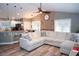 Open-concept living room with wood floors, ceiling fan, and view of kitchen at 1131 Camellia Dr., Surfside Beach, SC 29575