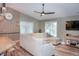 Well-lit living room with a large sofa, ceiling fan and wood accent wall at 1131 Camellia Dr., Surfside Beach, SC 29575
