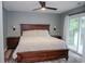 Spacious main bedroom with wood floors, a ceiling fan, and a sliding glass door to a deck at 1131 Camellia Dr., Surfside Beach, SC 29575