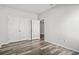 A simple bedroom space showcasing a closet with double doors and stylish wood-look flooring at 116 Old Chimney Ln, Conway, SC 29526