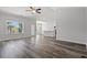 Spacious living room with wood-look floors, ceiling fan, and lots of natural light at 116 Old Chimney Ln, Conway, SC 29526