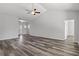 A spacious living area showcasing wood-look flooring and an open layout, illuminated by natural light at 116 Old Chimney Ln, Conway, SC 29526