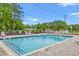 Community pool featuring several lounge chairs and green foliage at 116 Old Chimney Ln, Conway, SC 29526