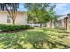Spacious backyard featuring a lush lawn, mature trees, and a white picket fence at 119 Berry Tree Dr., Pawleys Island, SC 29585