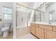Bright bathroom featuring a shower-tub combination and wood vanity with mirror at 119 Berry Tree Dr., Pawleys Island, SC 29585