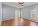 Cozy bedroom with hardwood floors, ceiling fan, and an ensuite bathroom at 119 Berry Tree Dr., Pawleys Island, SC 29585