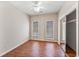 Bedroom features a ceiling fan, wood floors, a closet, and two windows for natural light at 119 Berry Tree Dr., Pawleys Island, SC 29585