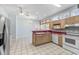 Bright kitchen boasts tile floors, stainless steel refrigerator, and ample cabinet space at 119 Berry Tree Dr., Pawleys Island, SC 29585