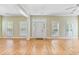 Spacious living area featuring gleaming hardwood floors and large windows for ample natural light at 119 Berry Tree Dr., Pawleys Island, SC 29585