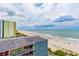 Elevated view showcasing beach access, oceanfront condos, and sandy beach with beachgoers and umbrellas at 1207 S Ocean Blvd. S # 50910, Myrtle Beach, SC 29577