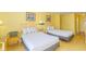 A bright hotel room features two beds, bedside table and lamps, and yellow-painted walls at 1207 S Ocean Blvd. S # 50910, Myrtle Beach, SC 29577
