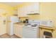 Efficient kitchenette featuring essential appliances: a refrigerator, stove, microwave, and coffee maker at 1207 S Ocean Blvd. S # 50910, Myrtle Beach, SC 29577