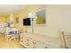 Bright, fully furnished living space with a TV and dining area and dresser, all near a kitchenette at 1207 S Ocean Blvd. S # 50910, Myrtle Beach, SC 29577