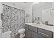 Bathroom featuring a decorative shower curtain, gray vanity, framed mirror, and brushed nickel accents at 136 Queens Cove Place # B, Myrtle Beach, SC 29579