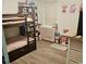 bedroom showcasing a bunk bed, dresser with a changing table, and laminate wood-look flooring at 136 Queens Cove Place # B, Myrtle Beach, SC 29579
