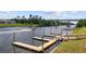View of boat docks on the waterway with a passing boat and a bridge in the background at 136 Queens Cove Place # B, Myrtle Beach, SC 29579