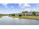 Scenic view of waterfront townhomes with lush green lawns and easy access to a lake at 136 Queens Cove Place # B, Myrtle Beach, SC 29579