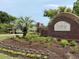 Welcoming community entrance featuring manicured landscaping and a brick sign, creating a great first impression at 136 Queens Cove Place # B, Myrtle Beach, SC 29579