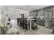 Charming kitchen with gray cabinets, granite countertops, island seating, and views of the spacious living area at 136 Queens Cove Place # B, Myrtle Beach, SC 29579