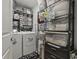 A tidy laundry room featuring a washer and dryer set, shelving units, and other storage solutions at 136 Queens Cove Place # B, Myrtle Beach, SC 29579