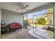 Relaxing screened porch with fan overlooking a lovely view, complete with comfortable seating and a table at 136 Queens Cove Place # B, Myrtle Beach, SC 29579