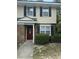 Close-up of the townhome's entrance with red front door and neat landscaping at 1432 Highway 544 # F1, Conway, SC 29526