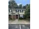 Charming townhome with brick accents, well-kept landscaping, and a classic red front door at 1432 Highway 544 # F1, Conway, SC 29526