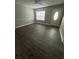 Bright living room featuring modern wood-look flooring, fresh paint, and ample natural light at 1432 Highway 544 # F1, Conway, SC 29526