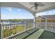 Covered balcony with a ceiling fan overlooks a grassy area and a waterfront at 1514 Lanterns Rest Rd. # 304, Myrtle Beach, SC 29579