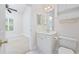 Bright bathroom featuring white cabinets, a vanity, and a toilet, plus the view into a bedroom at 1514 Lanterns Rest Rd. # 304, Myrtle Beach, SC 29579