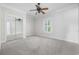 Light-filled bedroom features neutral carpet, a ceiling fan, window and mirrored closet at 1514 Lanterns Rest Rd. # 304, Myrtle Beach, SC 29579