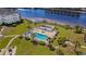 Aerial view of a community pool and hot tub with lounge chairs, umbrellas and meticulous landscaping at 1514 Lanterns Rest Rd. # 304, Myrtle Beach, SC 29579