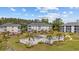 Aerial view of condo community showcasing the pool, palm trees, landscaping, and building exteriors at 1514 Lanterns Rest Rd. # 304, Myrtle Beach, SC 29579