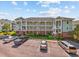 Low angle shot of attractive condo building featuring multiple floors, staircases and parking at 1514 Lanterns Rest Rd. # 304, Myrtle Beach, SC 29579