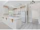 Bright kitchen with classic white cabinets, island, tile floors, and ample counter space at 1514 Lanterns Rest Rd. # 304, Myrtle Beach, SC 29579