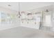 Bright kitchen with classic white cabinets, tile floors, and adjacent living area at 1514 Lanterns Rest Rd. # 304, Myrtle Beach, SC 29579