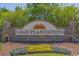 Community entrance sign surrounded by colorful flower beds and beautiful landscaping at 163 Sago Palm Dr., Myrtle Beach, SC 29579