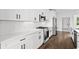 Bright kitchen featuring stainless appliances, white cabinets, modern countertops, and hardwood floors at 163 Sago Palm Dr., Myrtle Beach, SC 29579