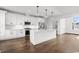 Bright, modern kitchen with stainless appliances, white cabinets, and hardwood flooring at 163 Sago Palm Dr., Myrtle Beach, SC 29579