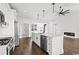 Well-designed kitchen features white cabinets, stainless appliances, island with seating, and hardwood floors at 163 Sago Palm Dr., Myrtle Beach, SC 29579