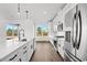 Bright kitchen features stainless appliances, island with seating, and sliding glass doors to the outdoor space at 163 Sago Palm Dr., Myrtle Beach, SC 29579