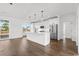 Open concept living room features modern kitchen with white cabinets, stainless appliances, and island seating at 163 Sago Palm Dr., Myrtle Beach, SC 29579