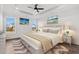 Bright, airy main bedroom with tray ceiling, hardwood floors, and lots of natural light from large windows at 163 Sago Palm Dr., Myrtle Beach, SC 29579
