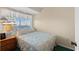 Comfortable bedroom with a queen-sized bed, a nightstand, and natural light from the window at 1709 S Ocean Blvd. S # 205, North Myrtle Beach, SC 29582