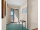 Hallway with a sliding glass door to a balcony with ocean views and beachy decor at 1709 S Ocean Blvd. S # 205, North Myrtle Beach, SC 29582